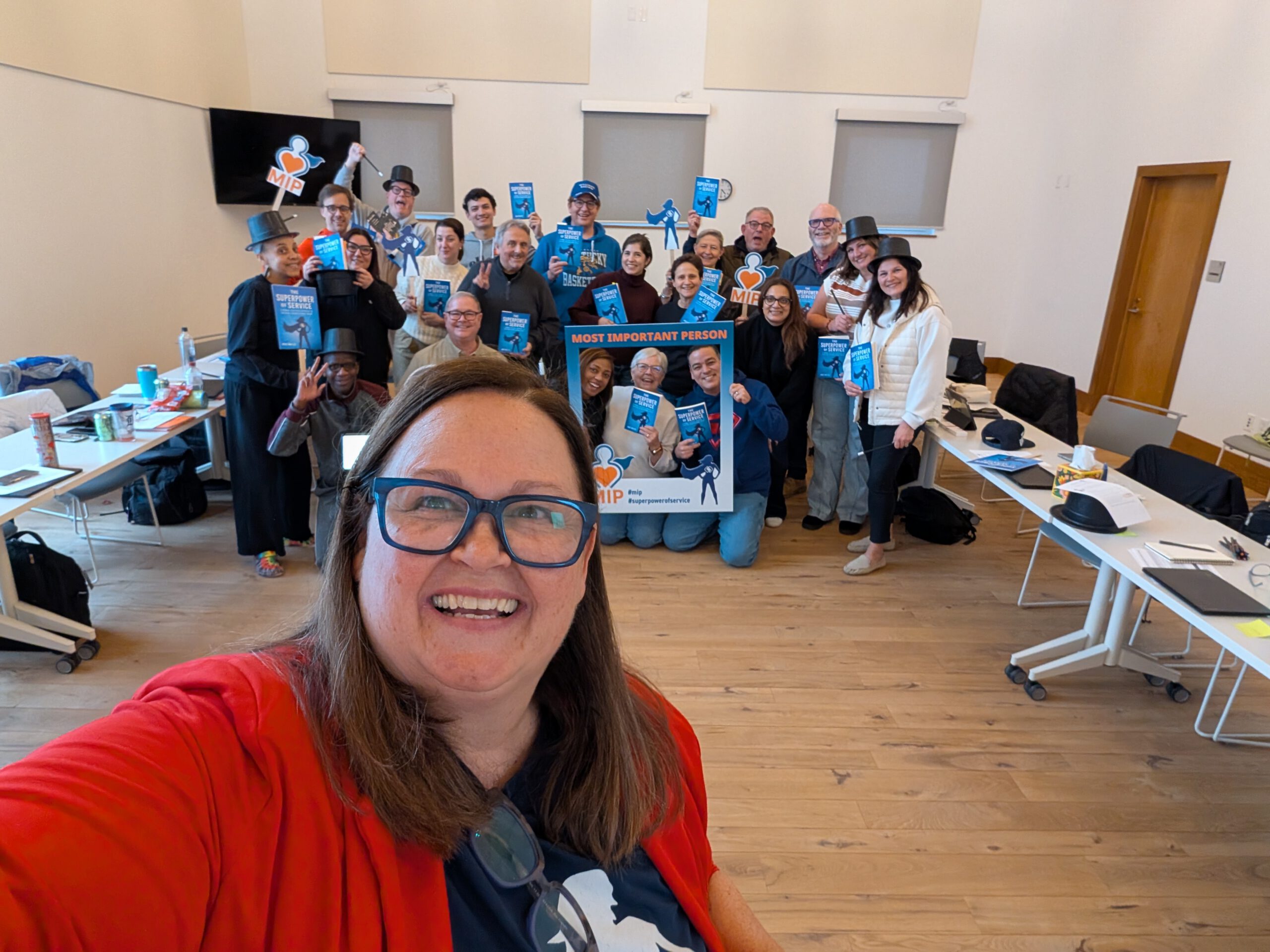 Josie taking a selfie with attendees in the background